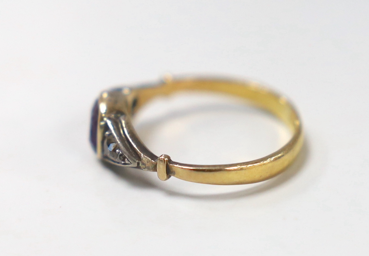 An antique 22ct gold and collet set amethyst ring, with graduated diamond set shoulders, size K, gross weight 2.6 grams.
